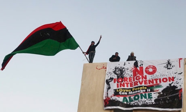 Demonstrators with the Kingdom of Libya flag in Benghazi on February 28, 2011 (Picture: Tiago Petinga/EPA) 