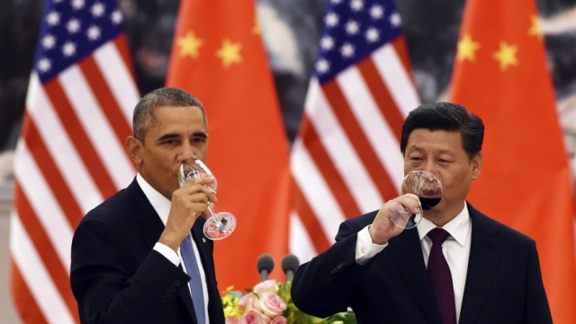 US President Barack Obama and Chinese President Xi Jinping raise a glass during a meeting between the two (PHOTO: Greg Baker/Pool/Reuters). 